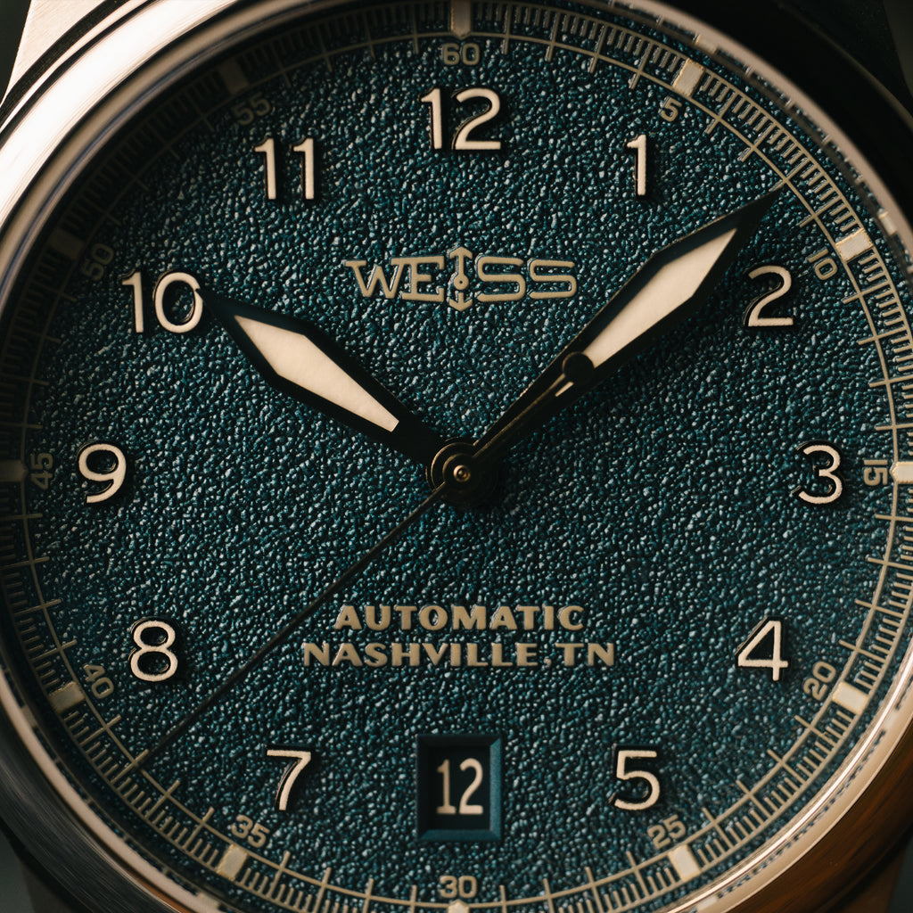 Close-up of a Weiss watch face with 'Weiss' branding and 'Automatic Nashville, TN' text.